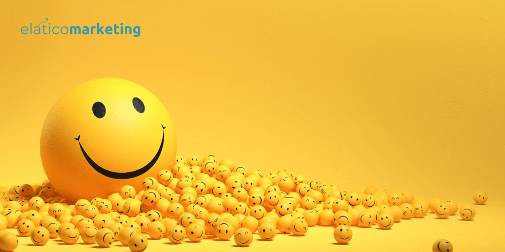 Emoji sonriente gigante rodeado de más emojis más pequeños